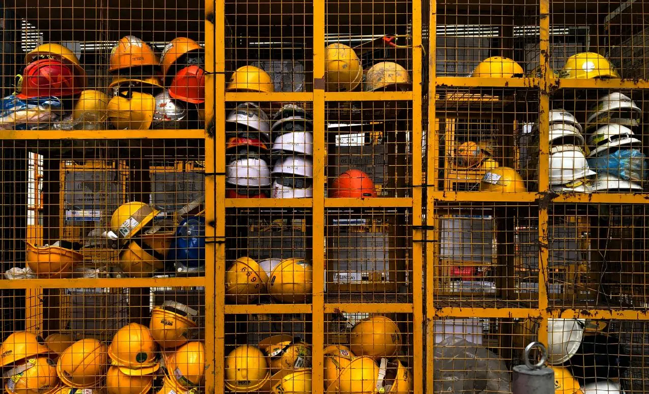 yellow construction helmets stacked on shelf